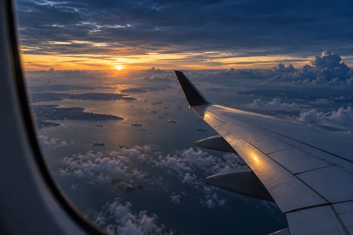 Sunrise over the sea through an aircraft window